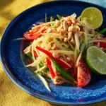 Authentic Thai Papaya Salad (Som Tum Thai) served with fresh ingredients